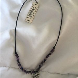 Brand New fossil, purple butterfly necklace.